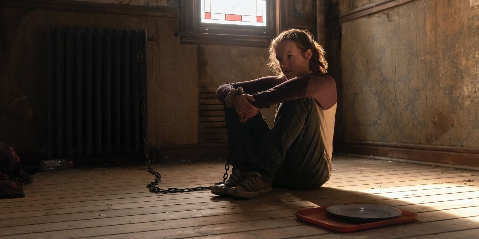 Ellie sits on the floor while chained up in HBO's The Last of Us