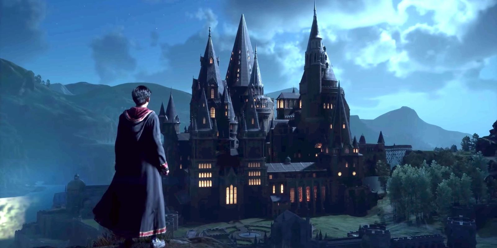 A student stands on a peak and gazes over Hogwarts