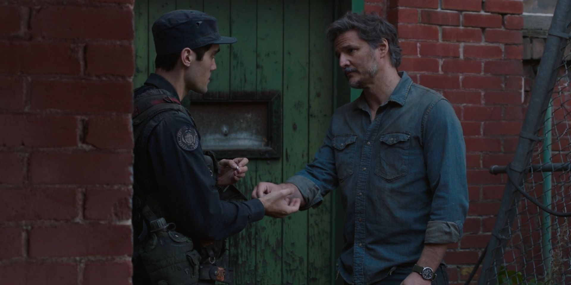 Joel hands Lee drugs in HBO's The Last of Us