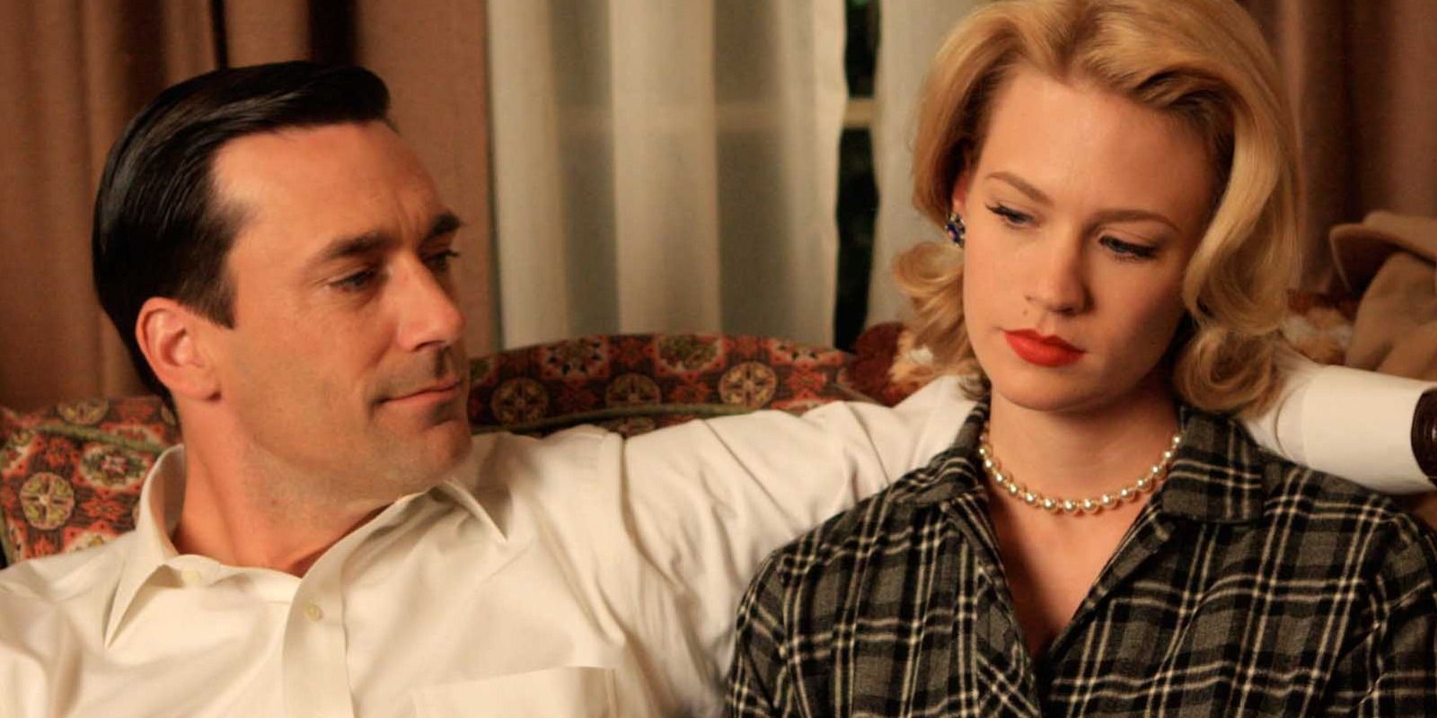 Don Draper puts his arm around Betty in an episode of Mad Men