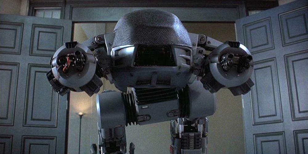 The ED-209 attacks businessmen in board room in RoboCop