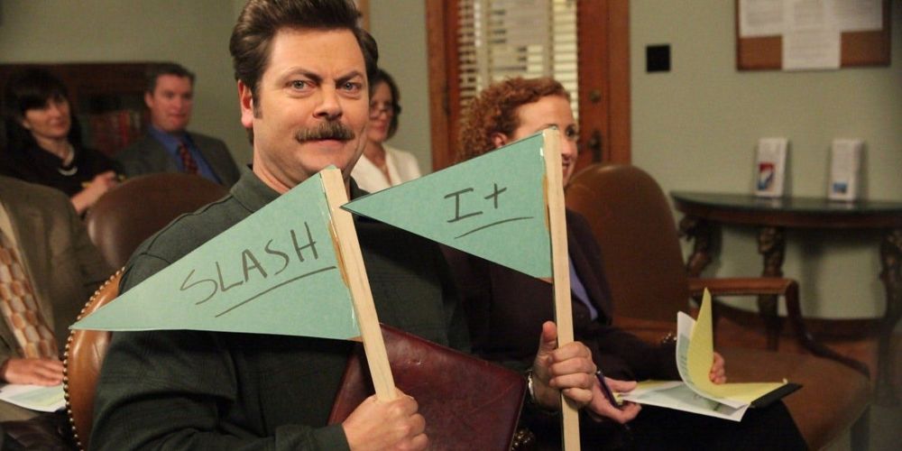 Ron Swanson holding up signs that say "Slash It"