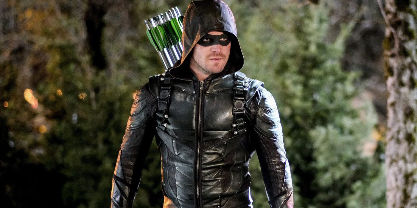 Stephen Amell as Oliver Queen in Arrow in a forest.