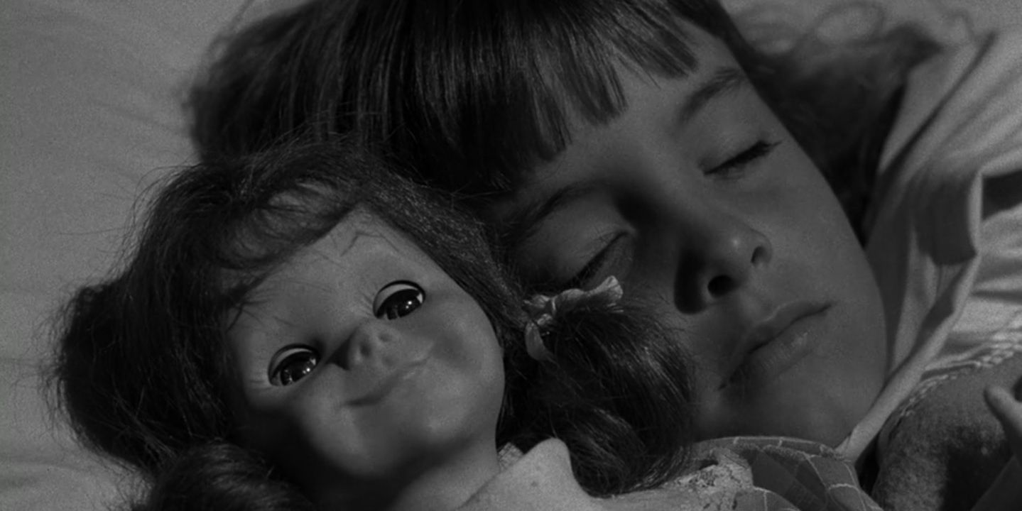Talky Tina sleeps with Christie in The Twlight Zone's "Living Doll."