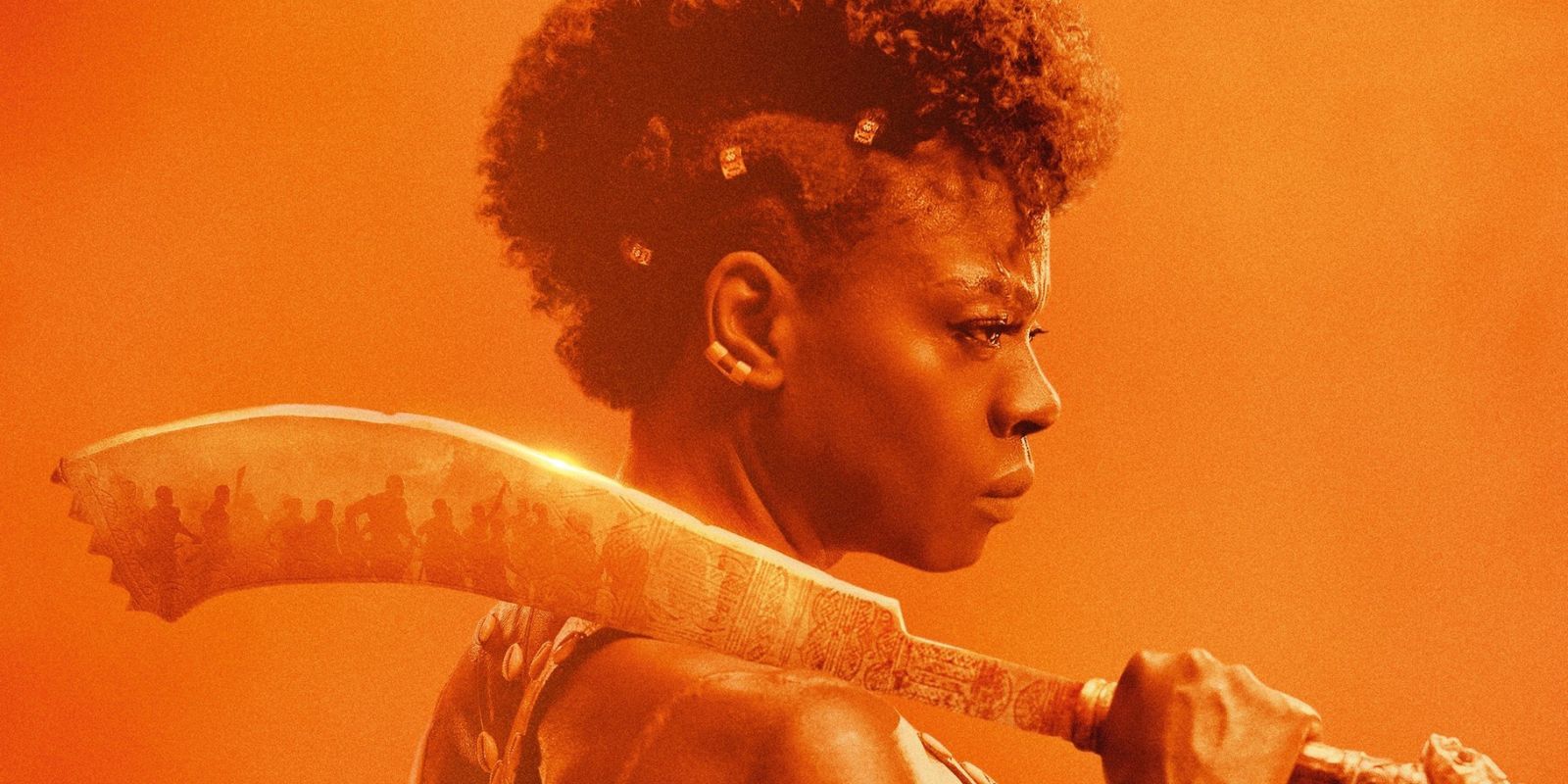 Viola Davis in The Woman King posing with a sword on her shoulder