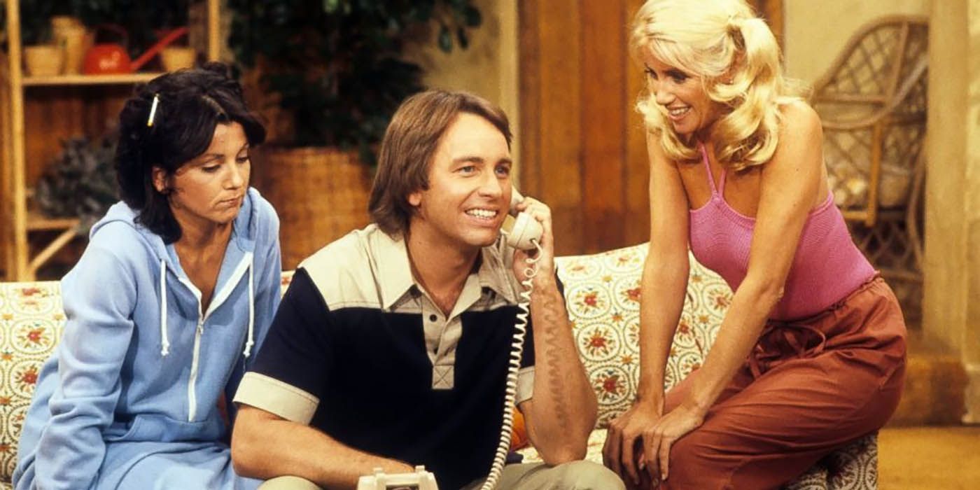 Jack Tripper on the phone surrounded by Jackie and Chrissy on Three's Company.