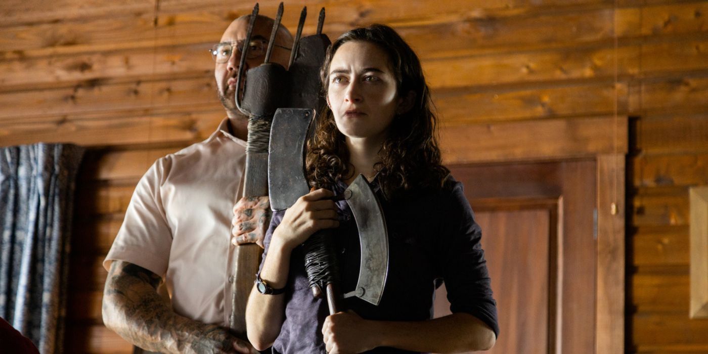 Leonard and Adriane arm themselves with weapons in a Knock at the Cabin still