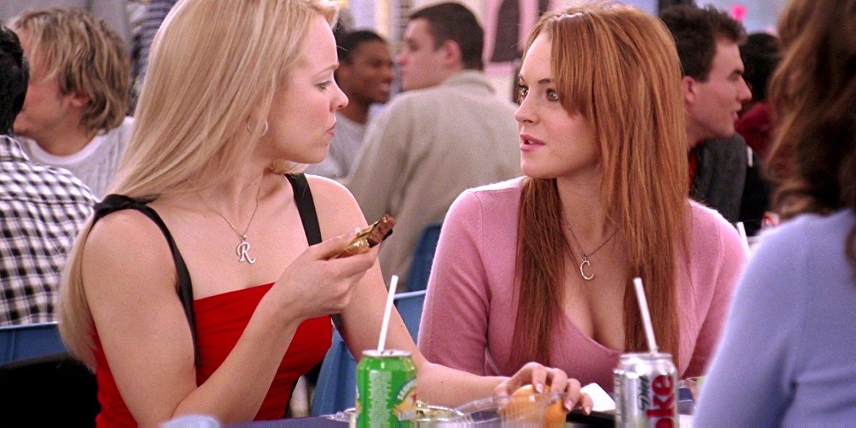 Cady and Regina looking at each other in the Mean Girls diner 