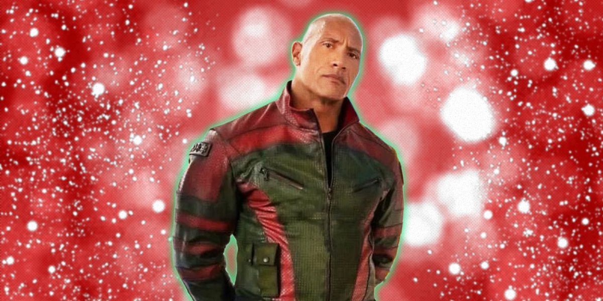 Dwayne Johnson wearing Red One jumpsuit over sparkling Christmas background