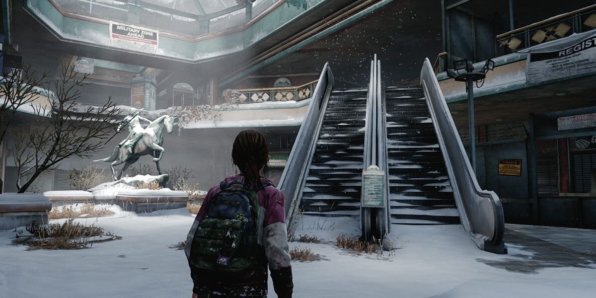Ellie looks at a statue and an escalator during the present day mall portion of the Left Behind DLC in The Last of Us Remastered