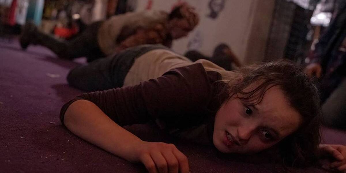 Ellie on the ground after being attacked by an Infected in episode seven of HBO's The Last of Us