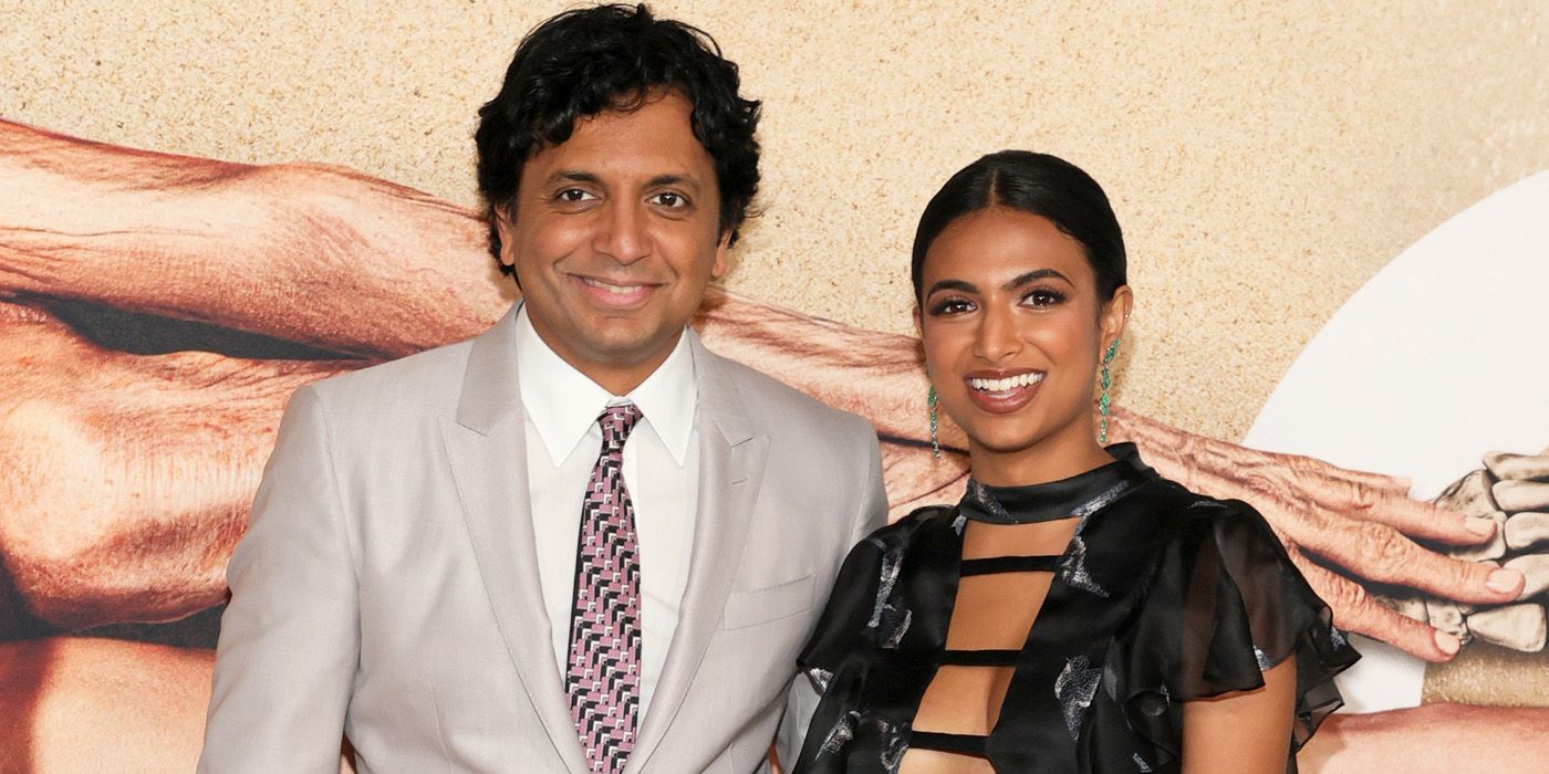 M. Night Shyamalan standing next to daughter Ishana Night Shyamalan at a premiere.