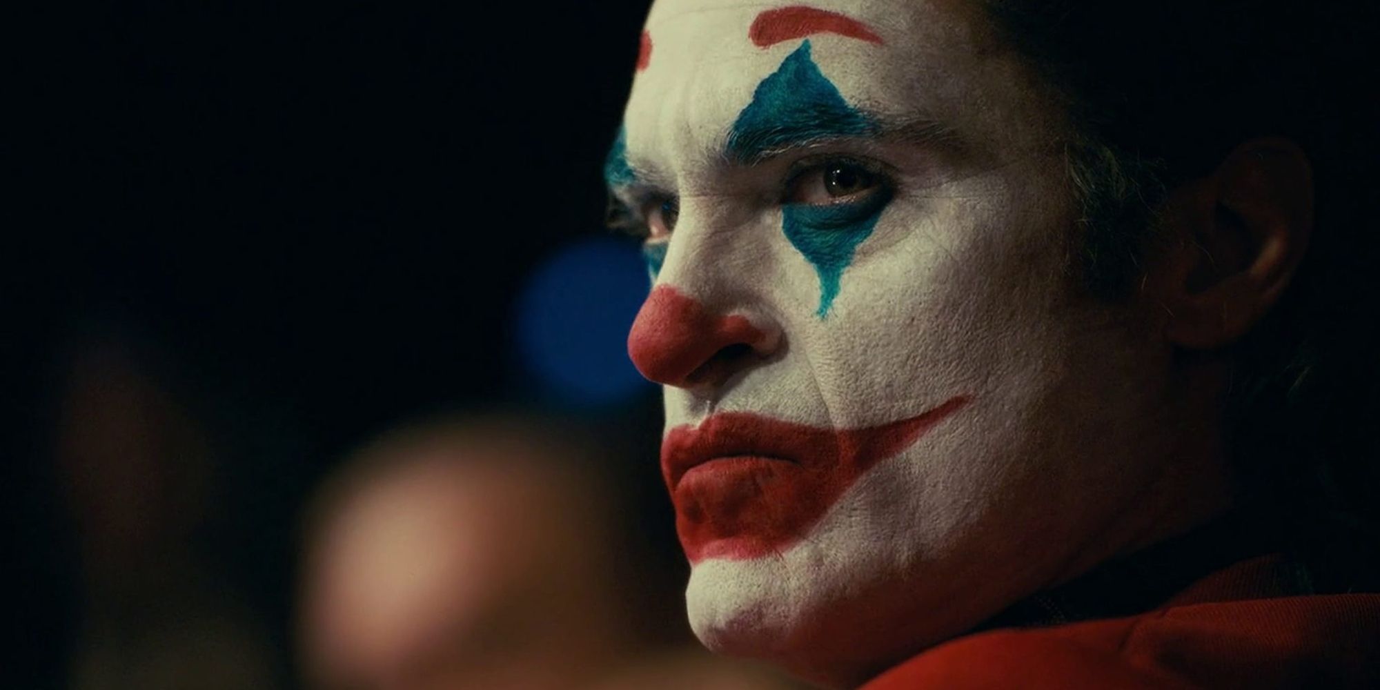 A close-up of Joaquin Phoenix in full Joker makeup.