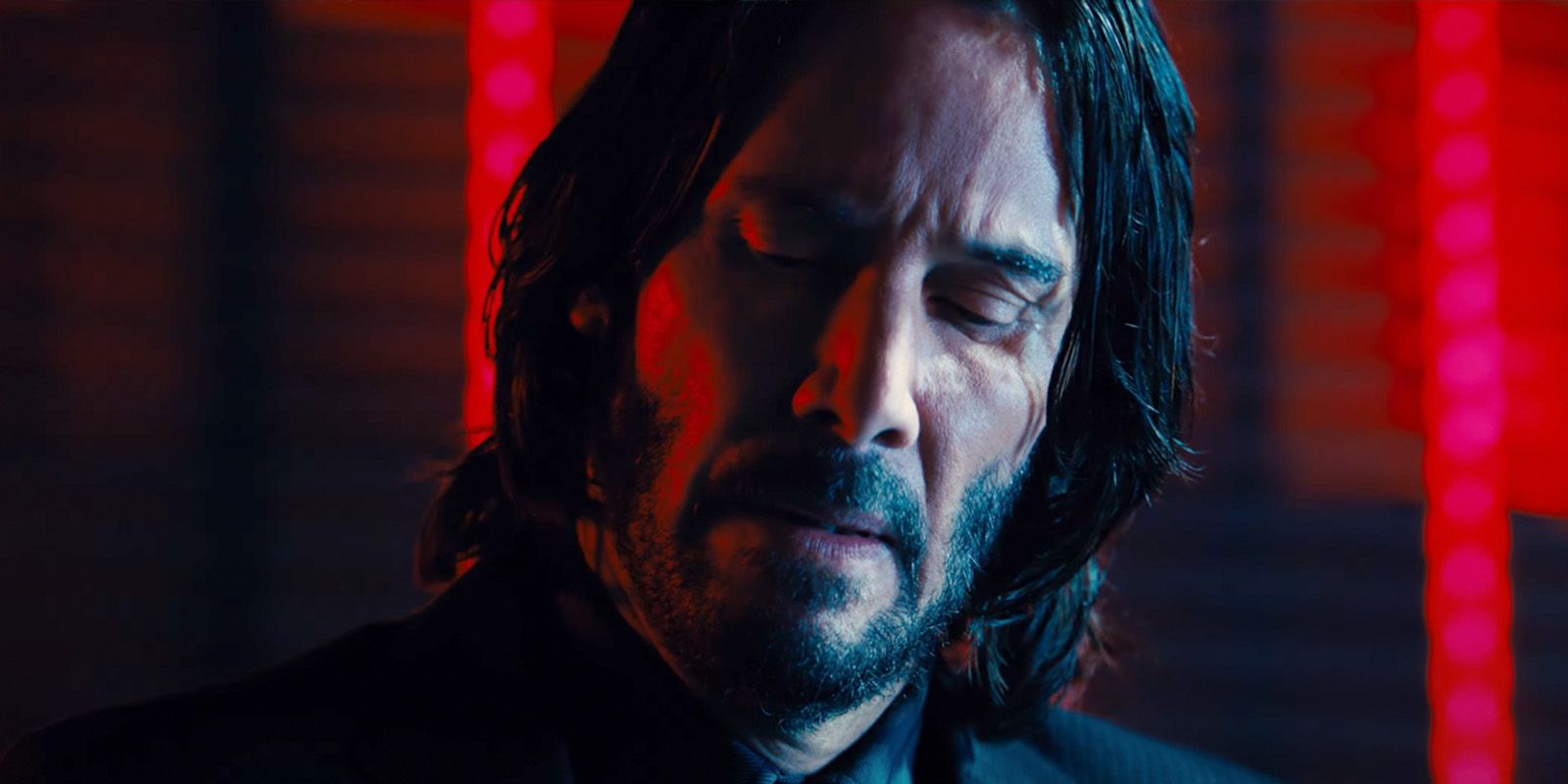 Keanu Reeves looks at something during scene in John Wick: Chapter 4