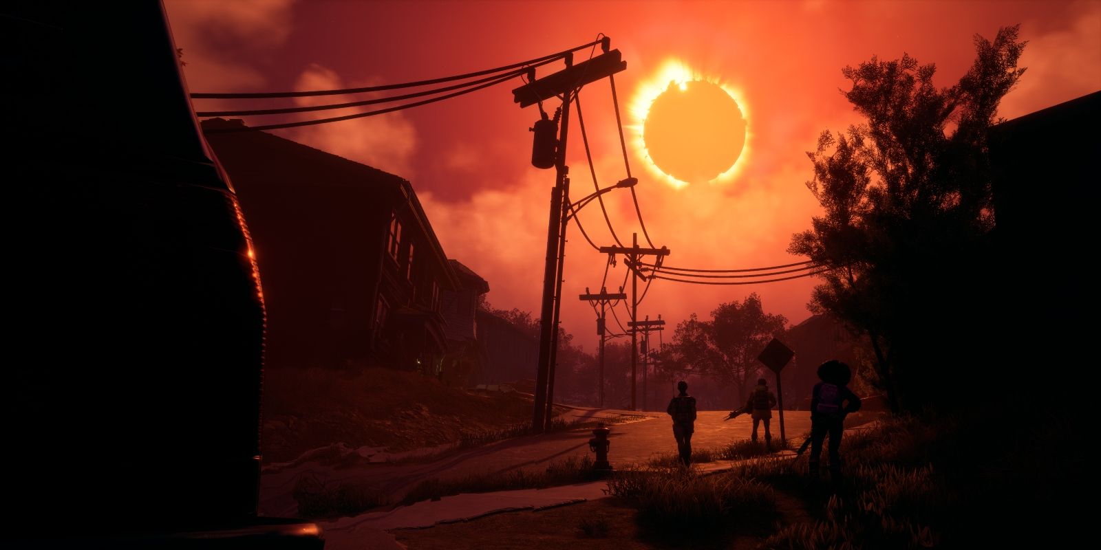 A screenshot from Redfall showing three players in the distance with a solar eclipse in the orange sky