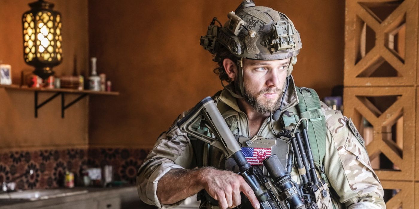 Clay holding a gun in his uniform on SEAL Team