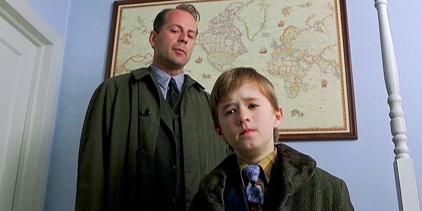 The Sixth Sense: Bruce Willis' Malcolm stands behind Haley Joel Osment's Cole.