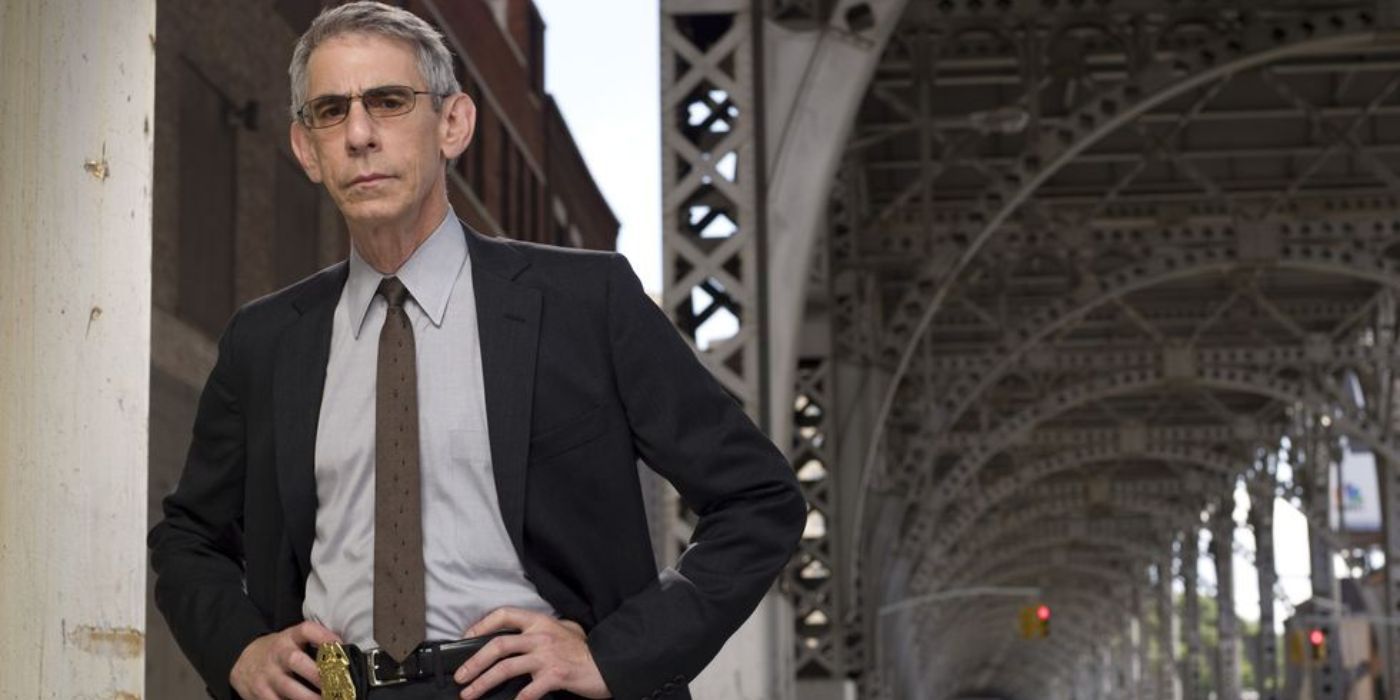 Richard Belzer poses as Detective John Munch with his hands on his hips