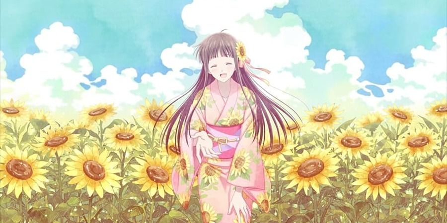 Tohru Honda siting in a field of sunflowers and extending her hand in friendship Fruits Basket