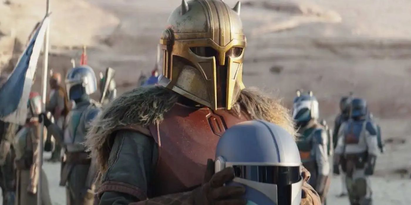 The Mandalorian's The Armorer presents a helmet to a new member of the Children of the Watch