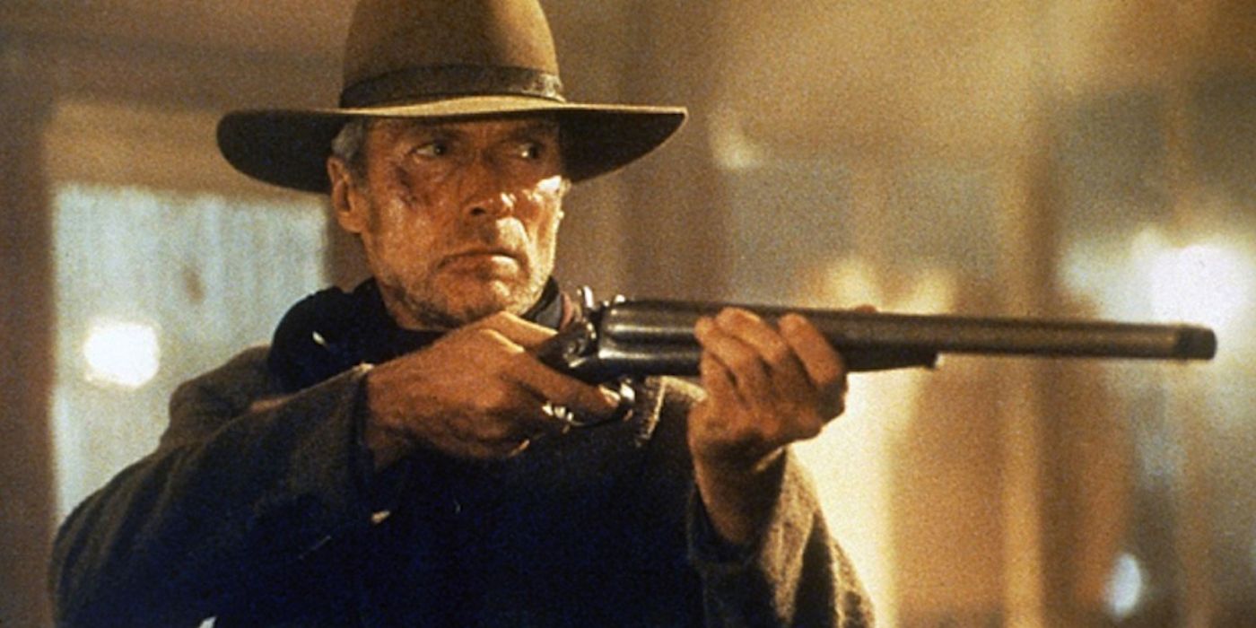 Clint Eastwood aims his weapon at another man in the finale of Unforgiven