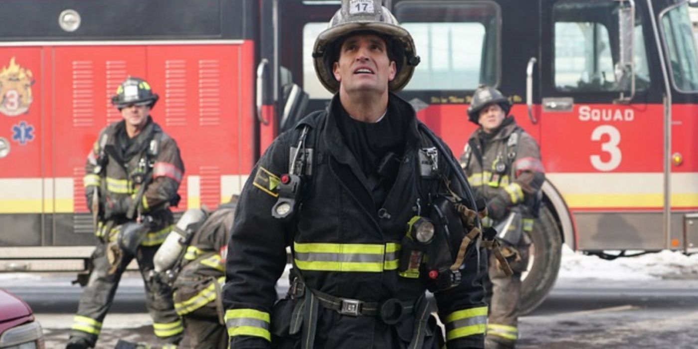 Pat Pridgen in firefighter gear looking up at a building in Chicago Fire