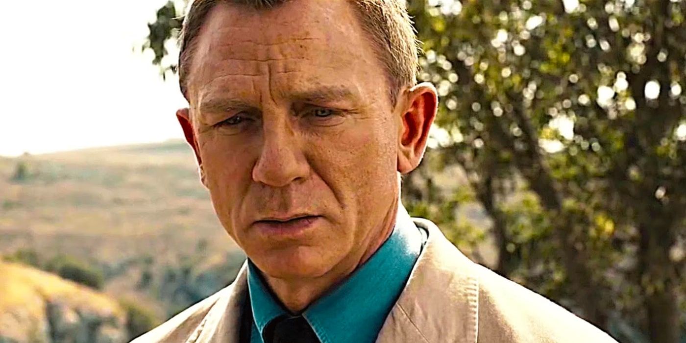 Daniel Craig's James Bond stands in a field during No Time to Die