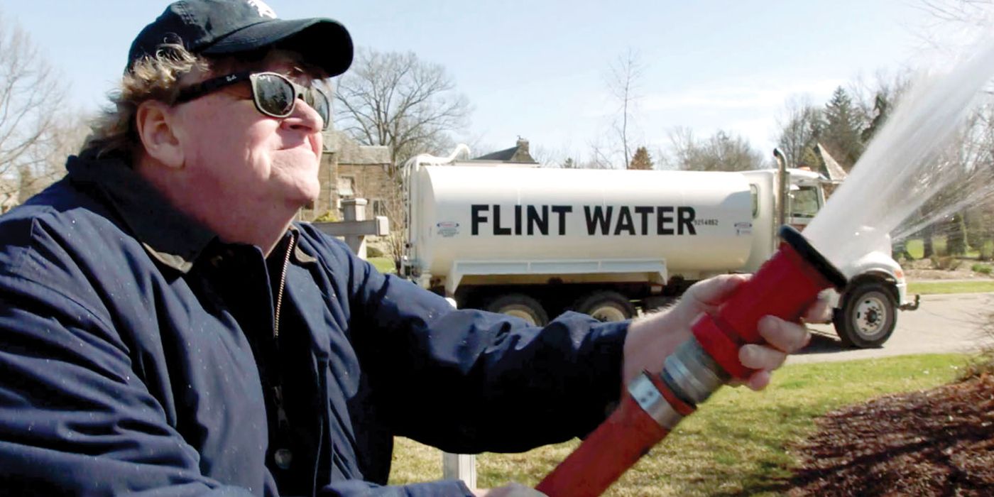 A man sprays water from a hose in a still from the documentary Fahrenheit 9/11