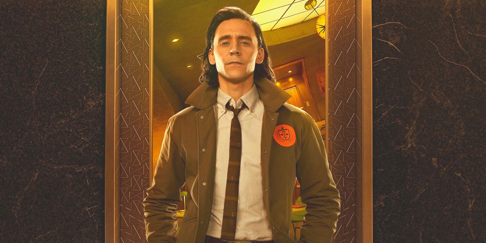 Loki, played by Tom Hiddleston, is standing in a doorway, showing off his tie and TVA jacket