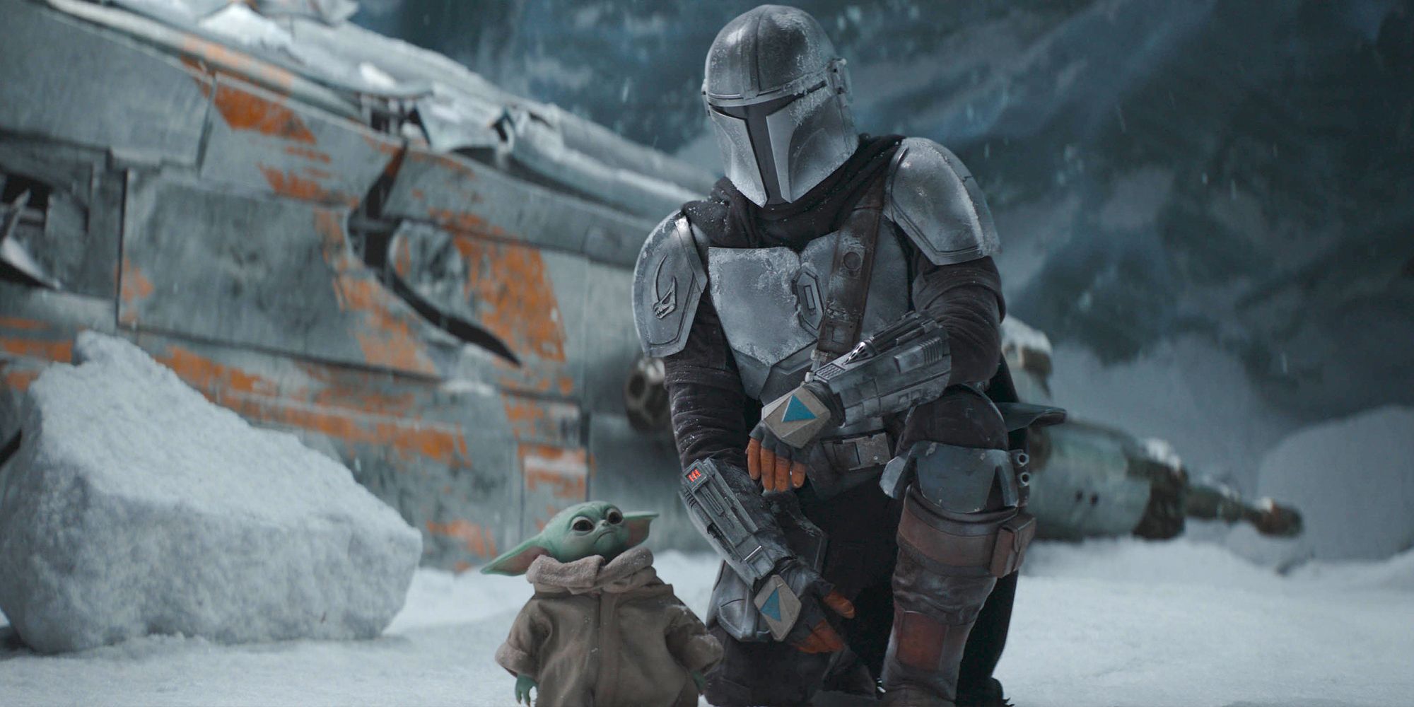 The Mandalorian and Grogu inspect the snowy ground.