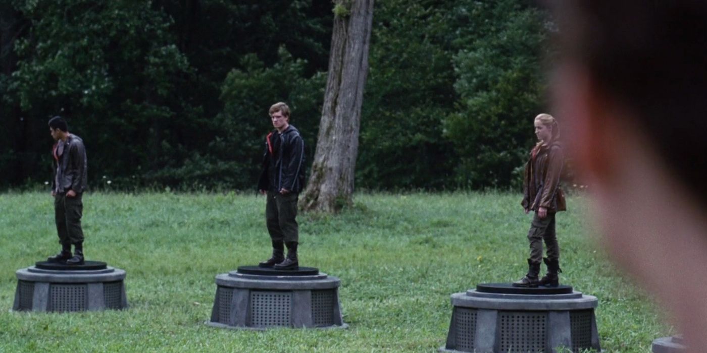 Homenagens, incluindo Peeta Mellark, em pedestais no filme Jogos Vorazes