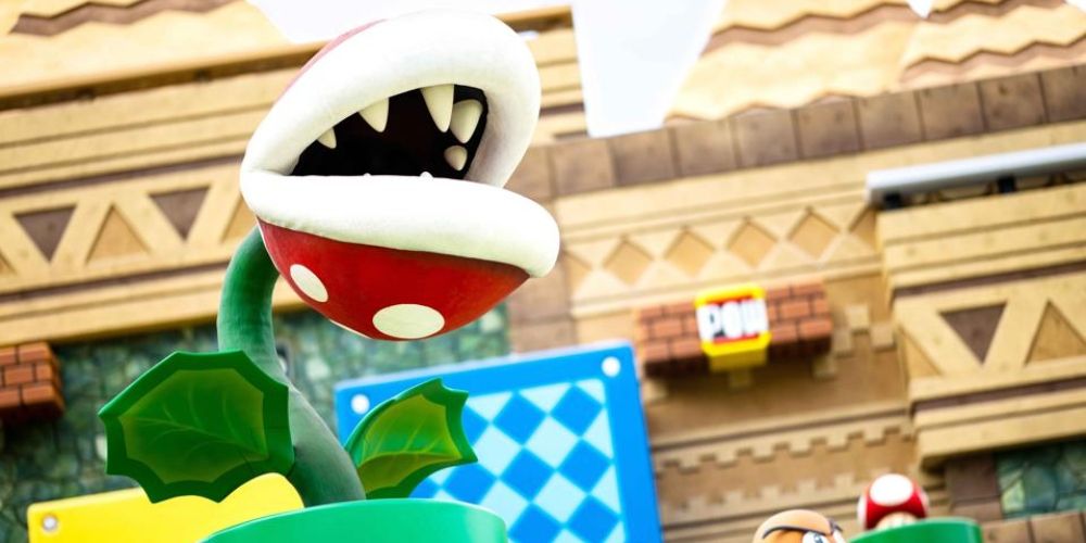 A Piranha Plant in Super Nintendo World with a POW block in the background.