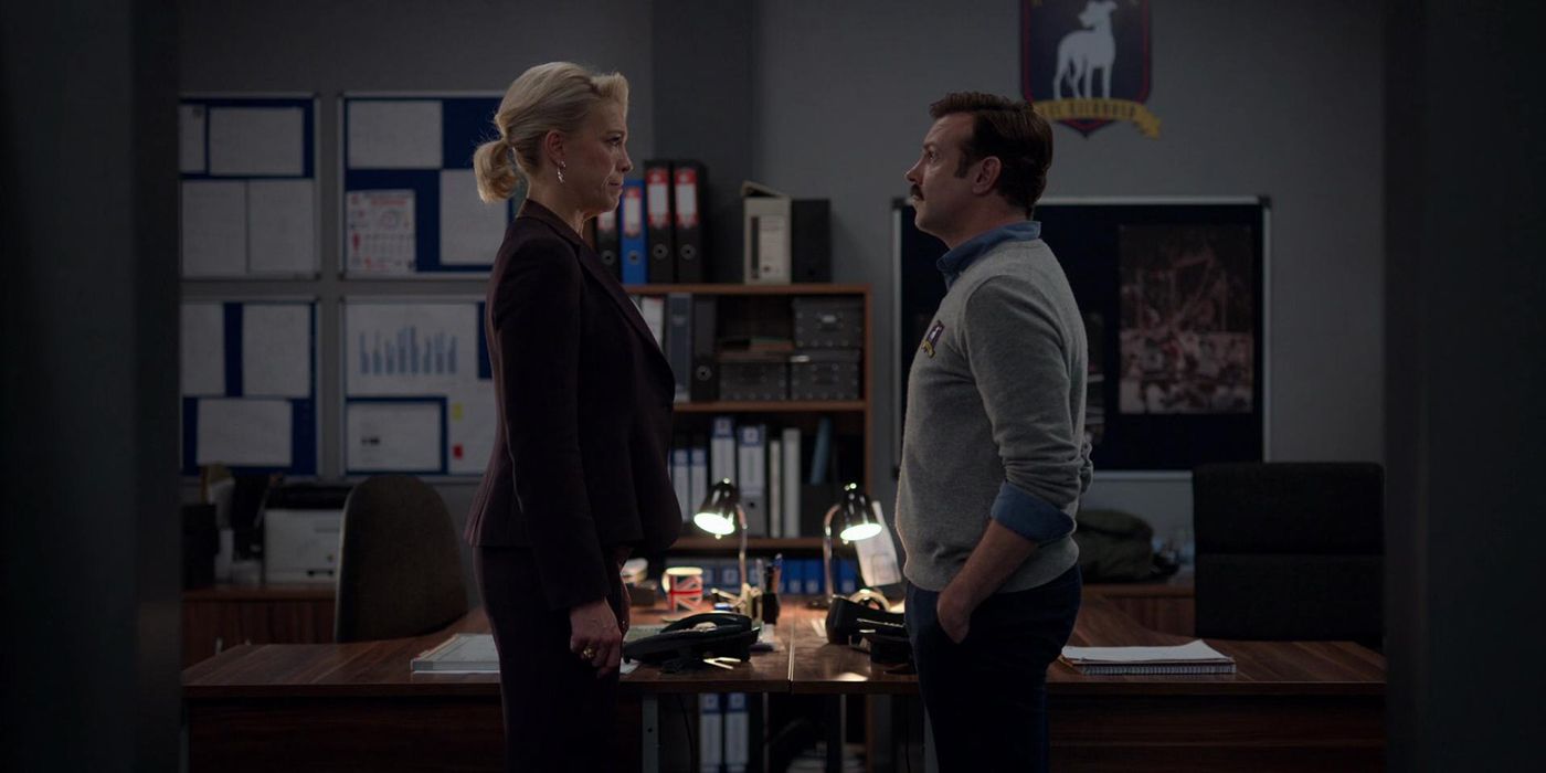 Rebecca and Ted stand face to face in her office in Ted Lasso.