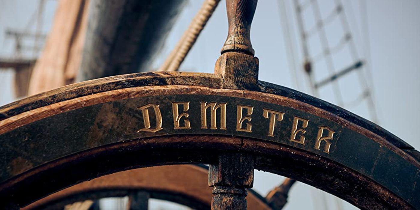 The steering wheel of a ship that reads "Demeter" from The Last Voyage of the Demeter.