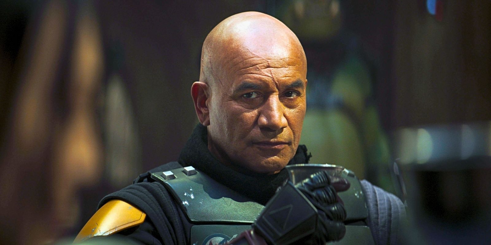 Temuera Morrison as Boba Fett drinking from a goblet in the Star Wars series The Book of Boba Fett