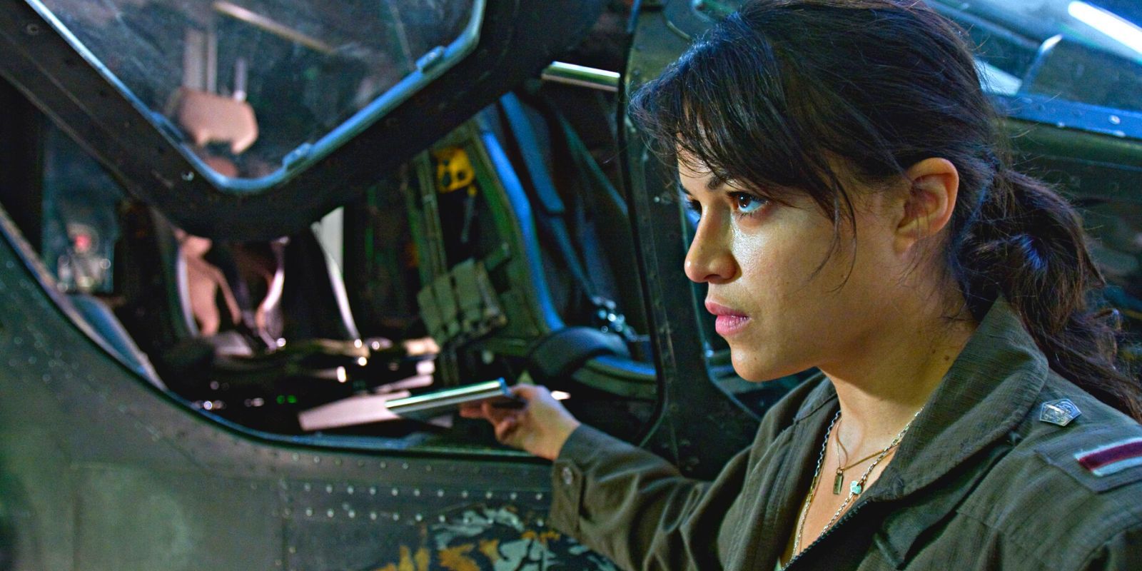 Michelle Rodriguez looking angrily past a military machine in Avatar