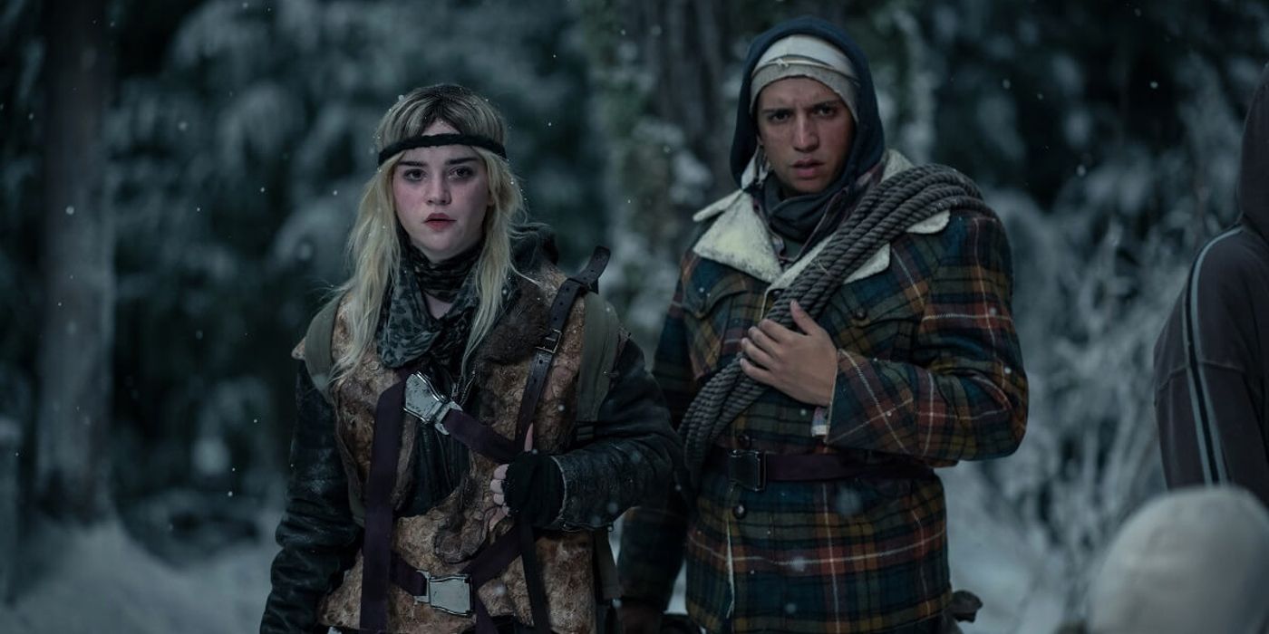 Natalie and Taissa stand outside in a snow-covered forest in Yellowjackets Season 2