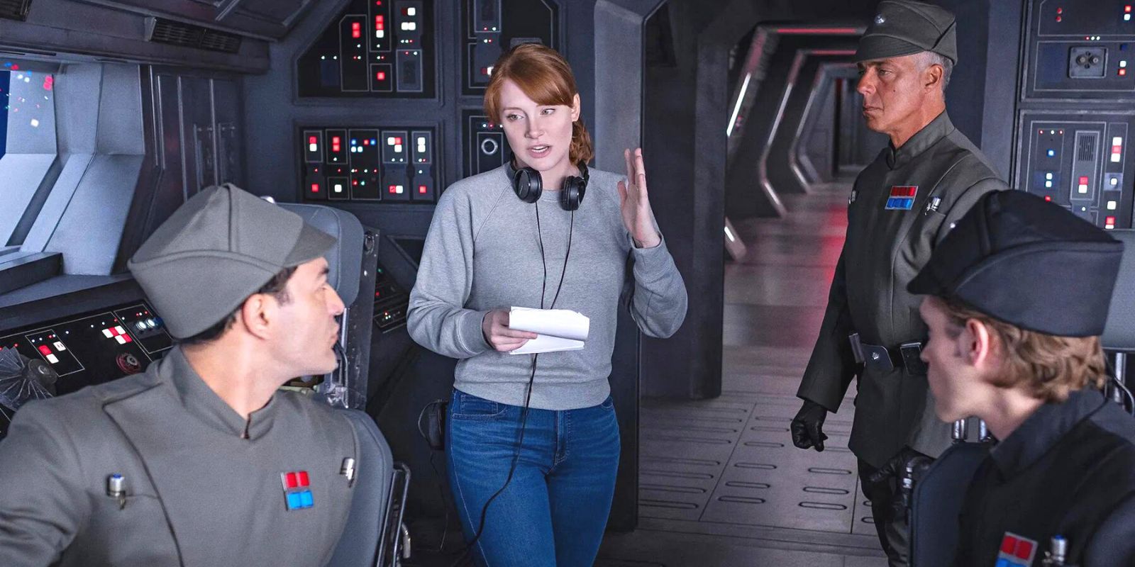 Bryce Dallas Howard standing in a room of Imperial Officers, giving them directions