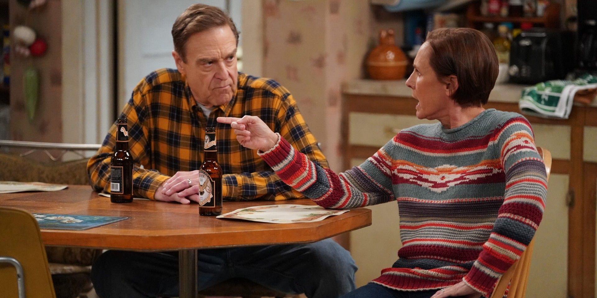 The Conners' Dan (John Goodman) stares at an angry, pointing Jackie (Laurie Metcalf).