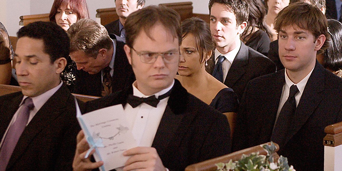 Dwight looking around Phylllis' wedding while sitting next to coworkers from The Office