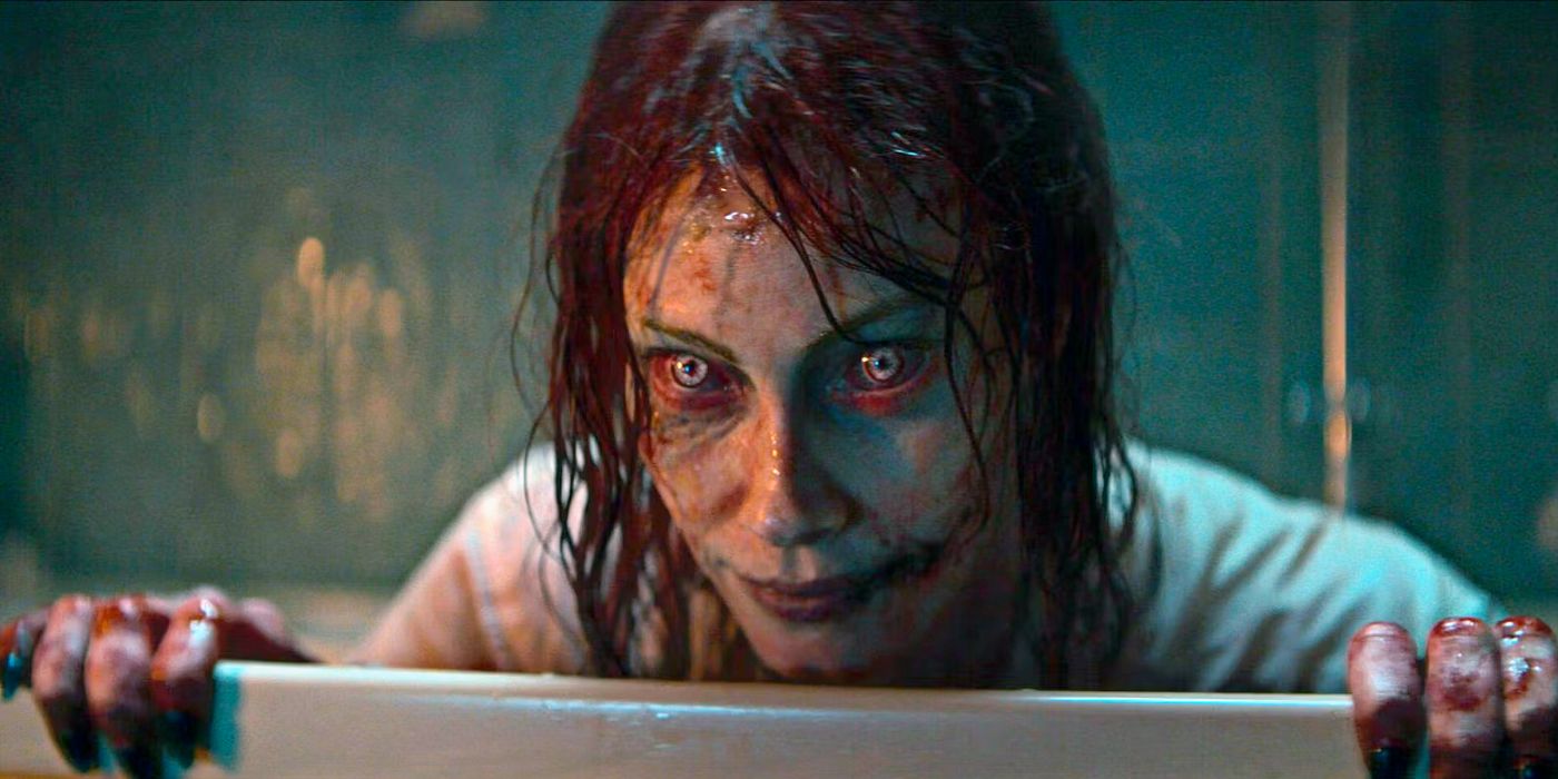 The possessed Ellie of Evil Dead Rise peeks over the edge of a bathtub.