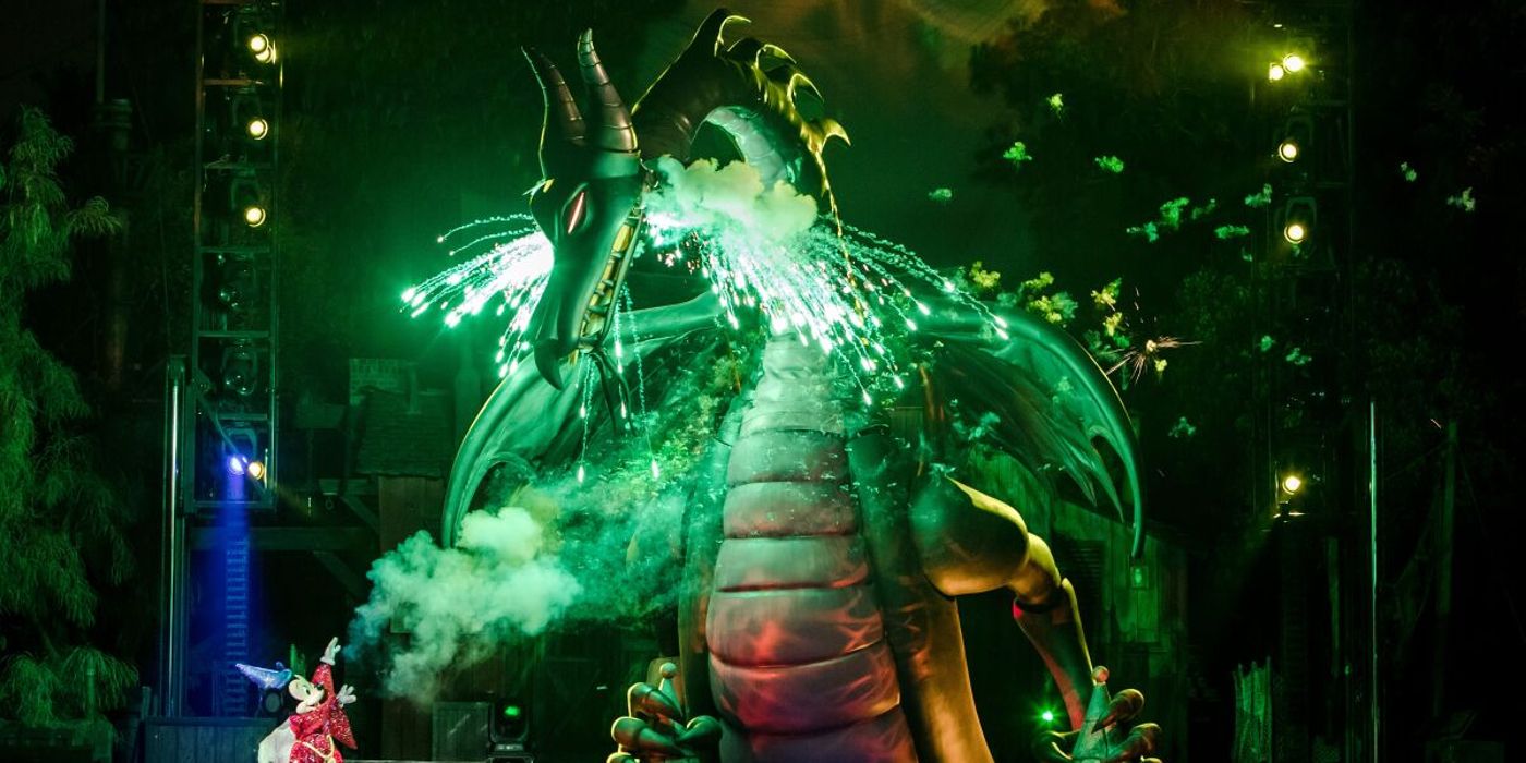 Disneyland's Fantasmic dragon spewing green sparks and flames from its mouth during a nighttime live show