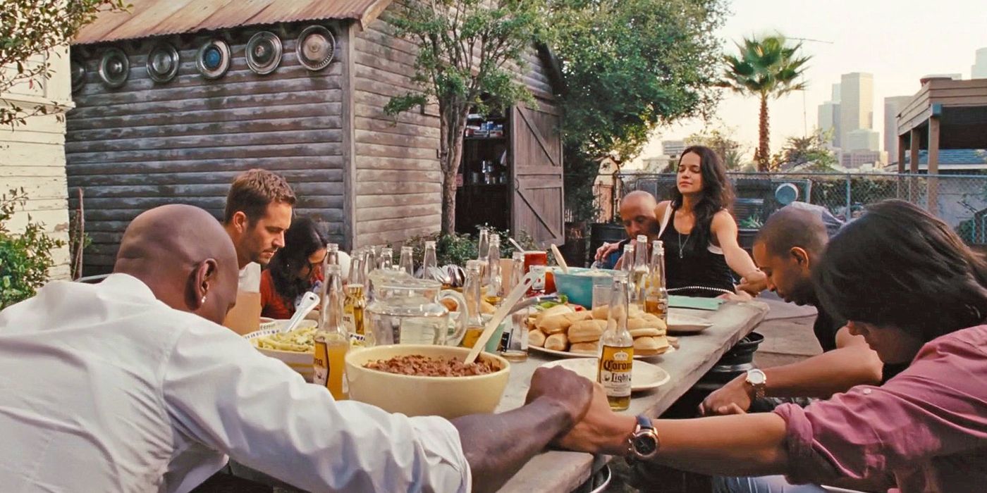Dominic Toretto enjoys a barbeque outside with his family in Fast & Furious 6.