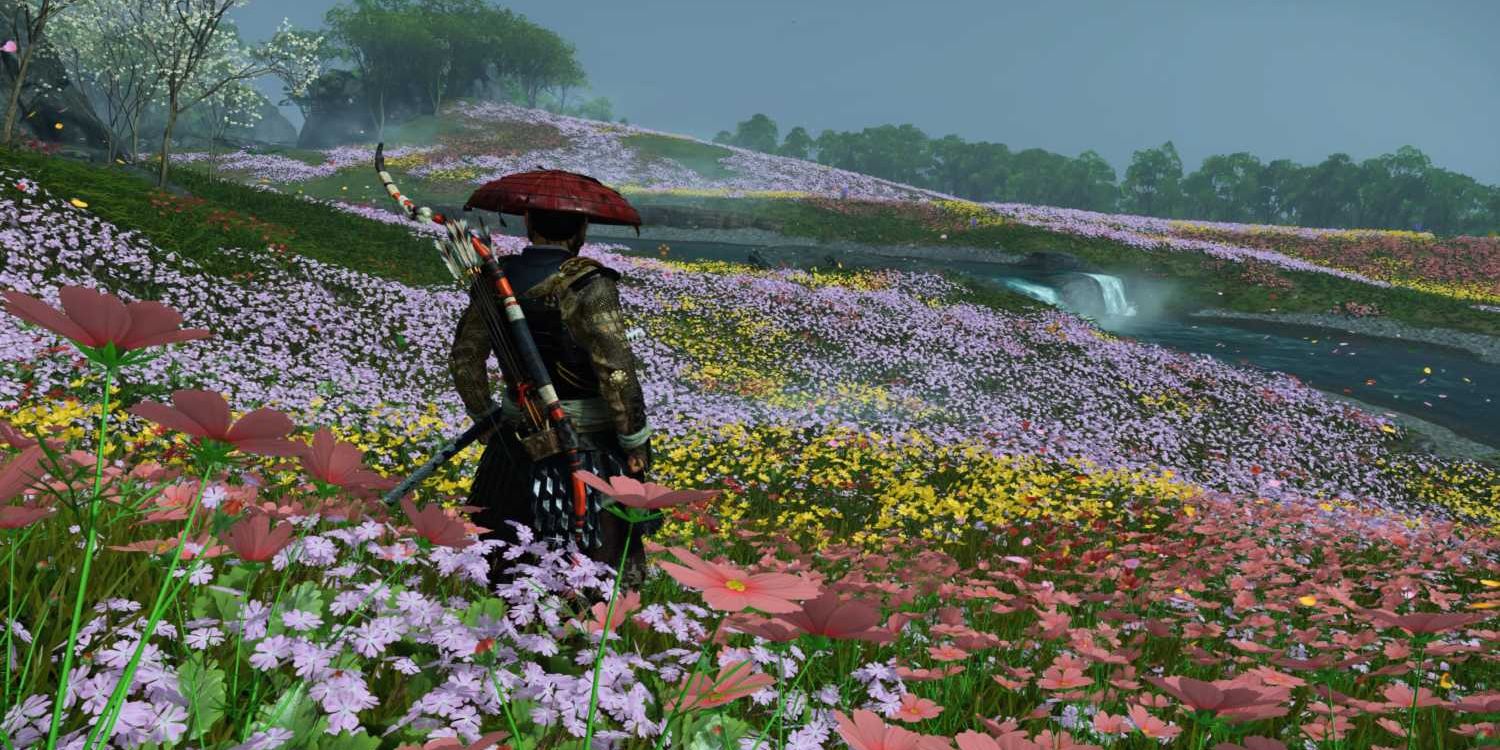 Jin Sakai stands on a colorful and flowery field in Ghost of Tsushima