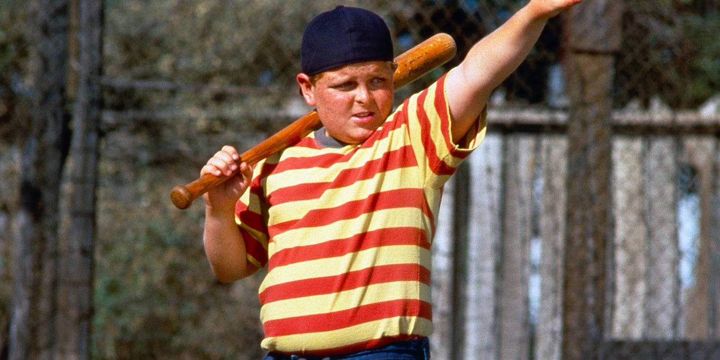 Ham from Sandlot puts his arm in the air while holding a baseball bat