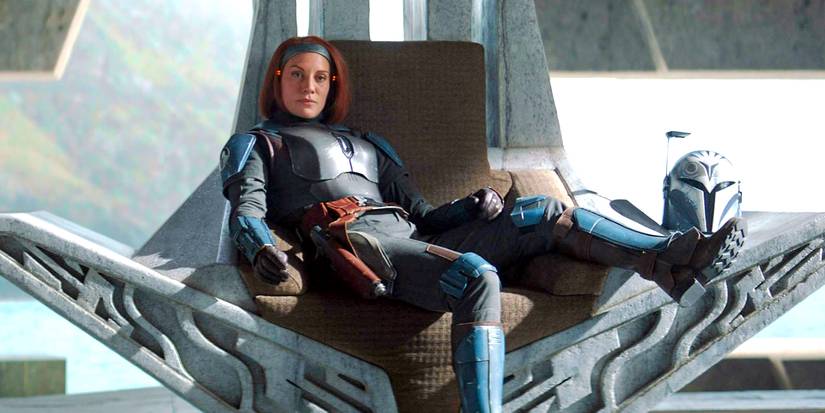 Bo-Katan Kryze (Katee Sackhoff) sprawled across a throne wearing her silver armor in The Mandalorian