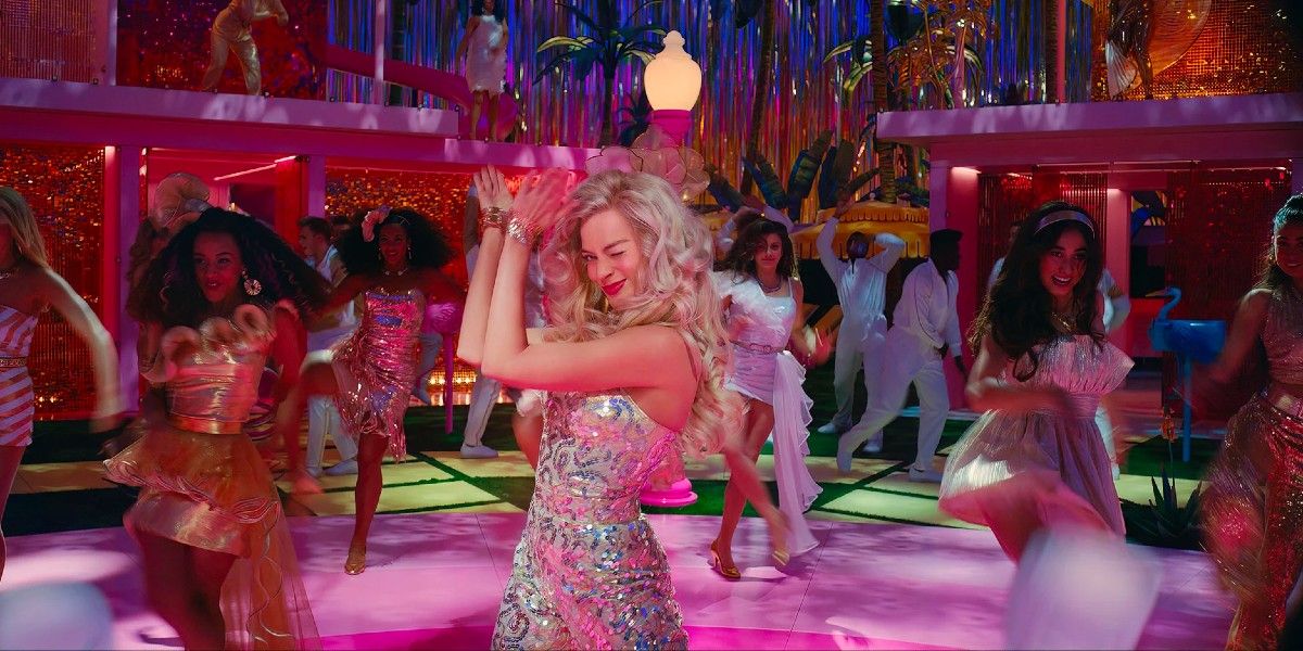 Margot Robbie dancing among friends in Barbie.