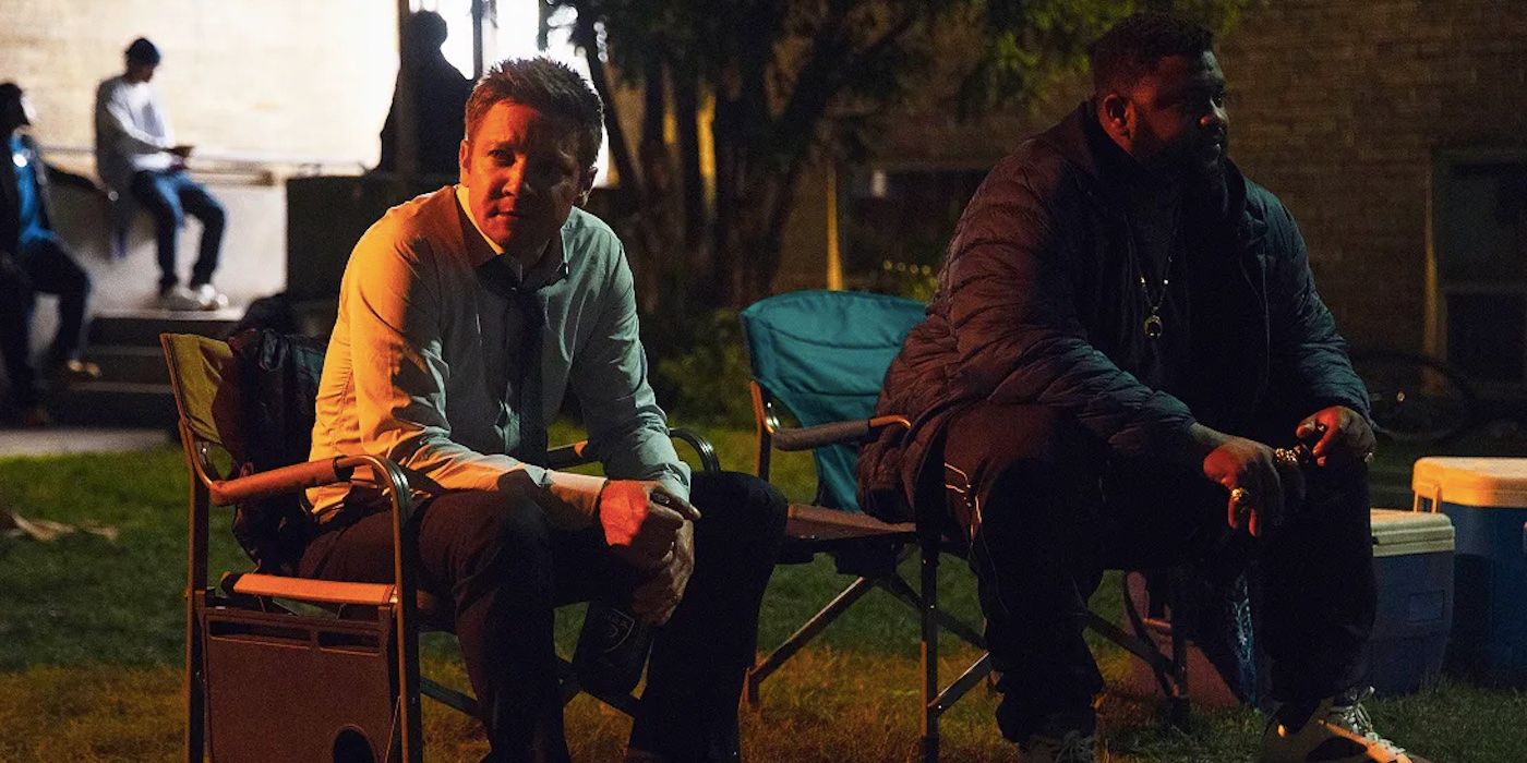Mike (Jeremy Renner) and Bunny (Tobi Bamtefa) sitting in lawn chairs in Bunny's place