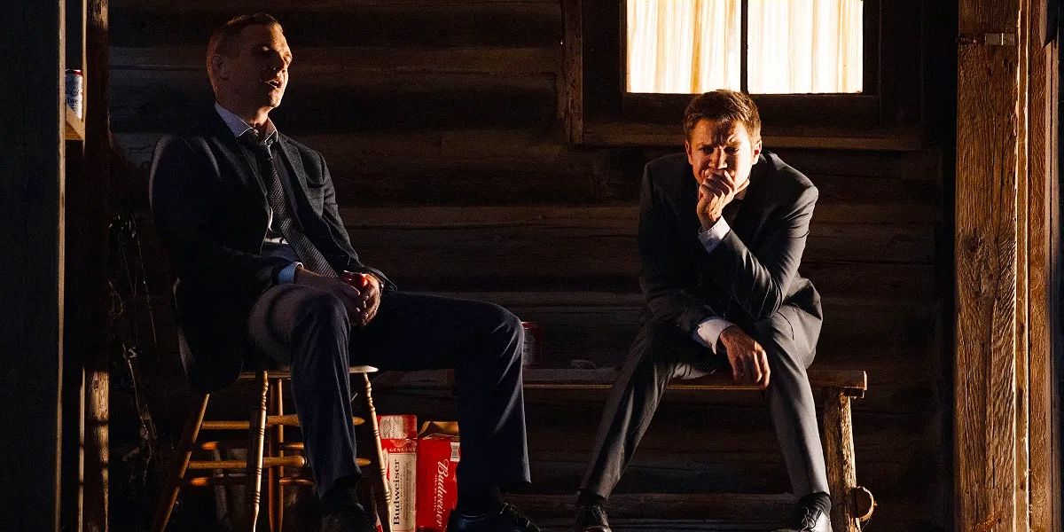 Kyle (Taylor Handley) and Mike (Jeremy Renner) sitting at a cabin in Mayor of Kingstown