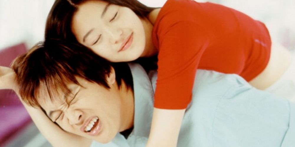 A woman smiles and annoyingly hugs a man in the unofficial sequel, My Sassy Girl 2